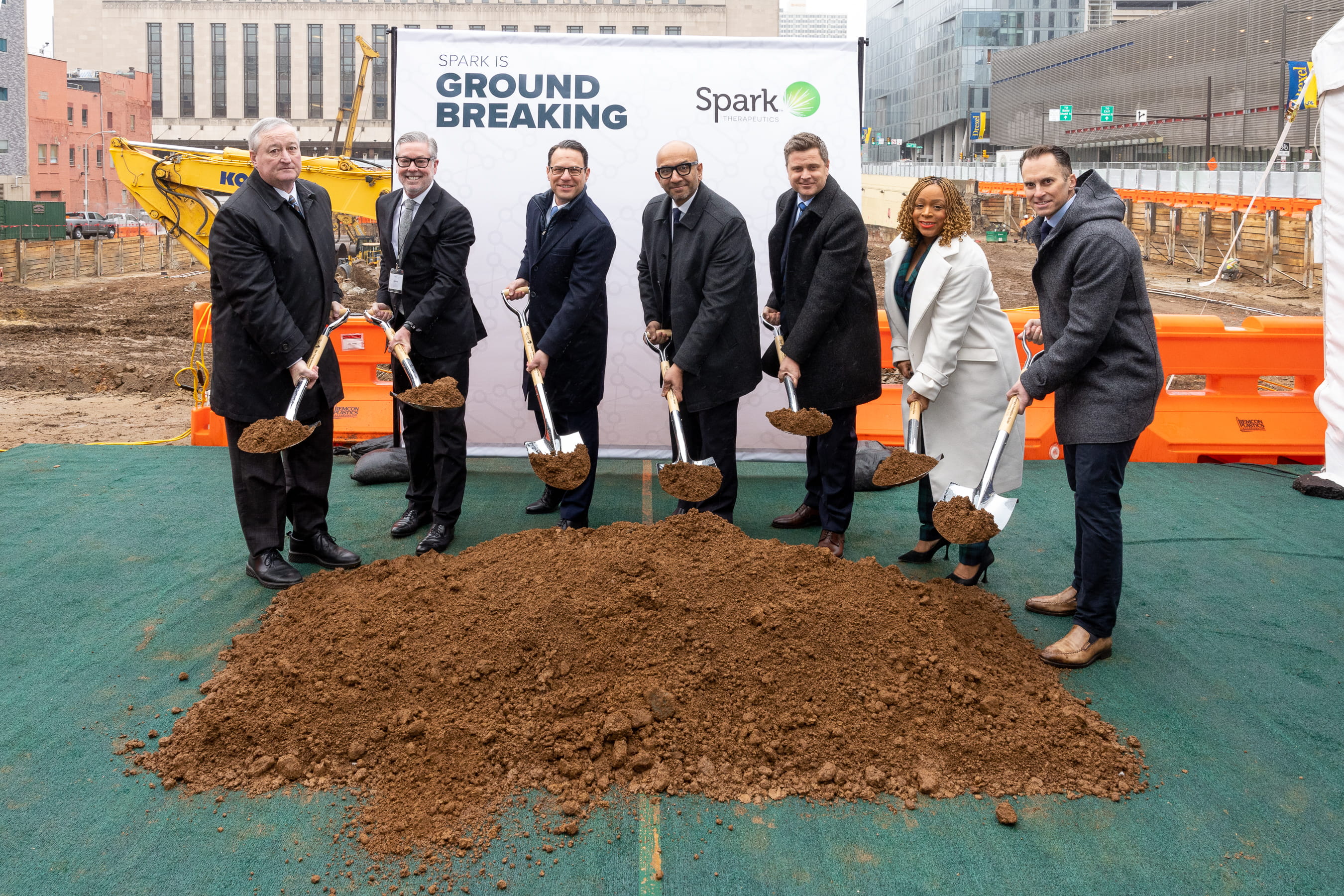 President John Fry standing with former Philadelphia Mayor John Kenny, PA governor Josh Shapiro, and other city officials at Spark Therapeutics construction site. All are posing with shovels.