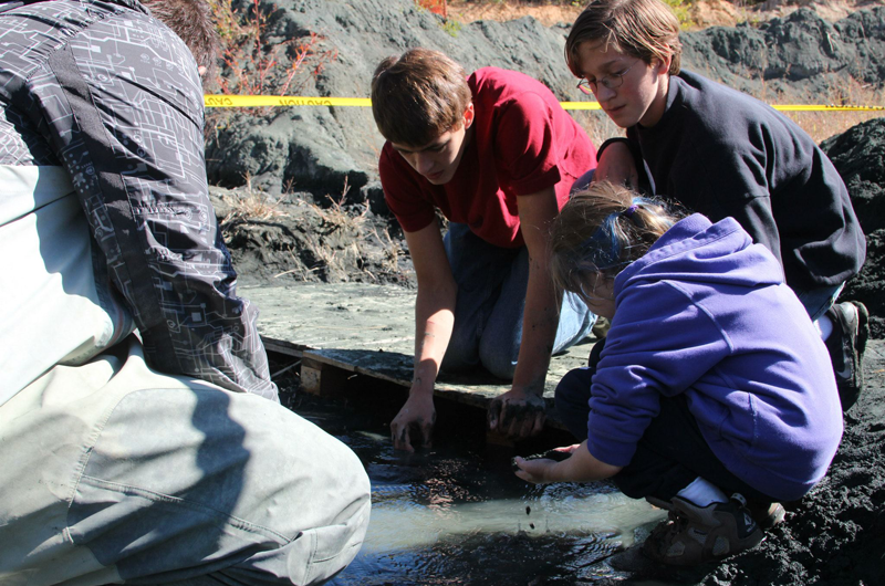 Children and teens dig for fossils.