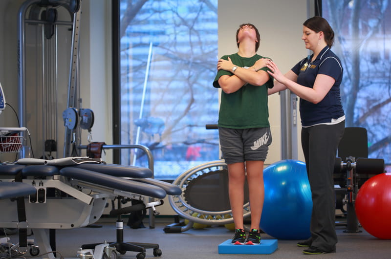 Sara Tomaszewski, a clinical instructor for physical therapy at Parkway Health & Wellness, works with a patient in the new 23,000-square-foot space in Center City.