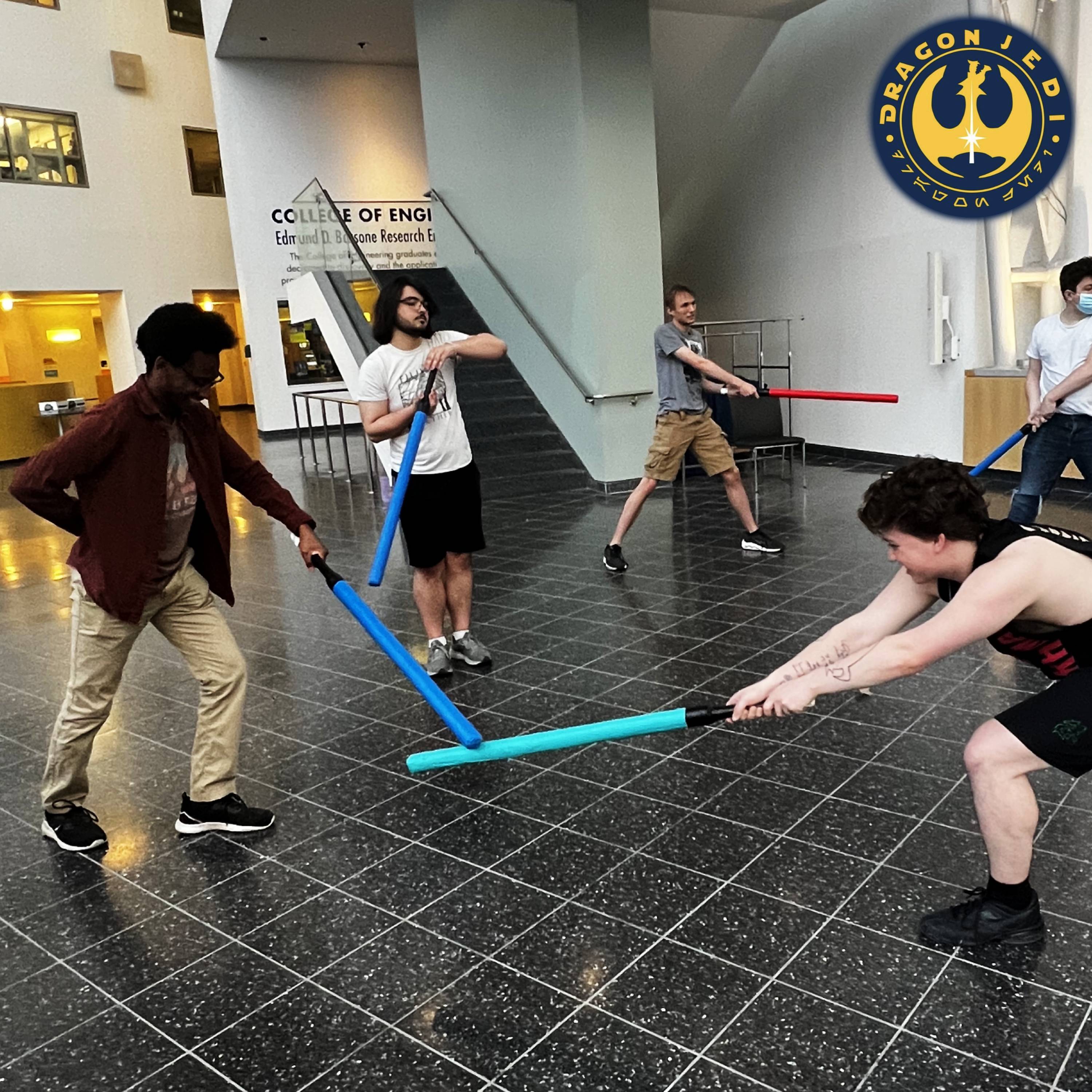 Students practicing with soft lightsabers