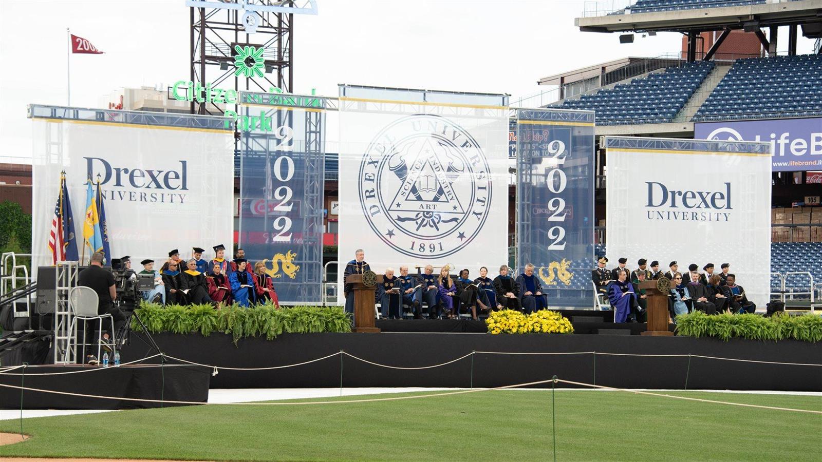 Drexel President John Fry speaks from a stage at Citizens Bank Park for Commencement 2022. 