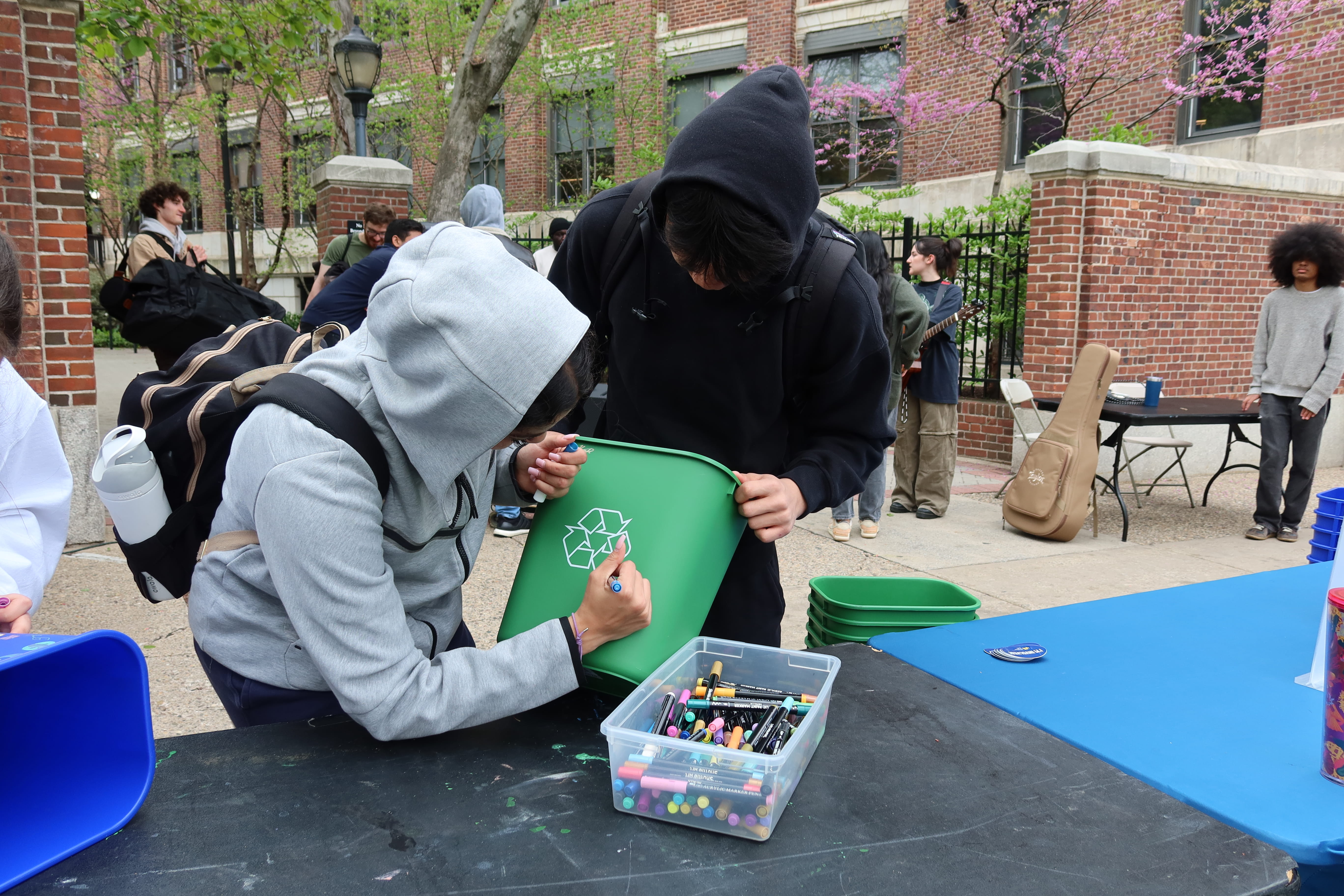 students decorating recycle bin