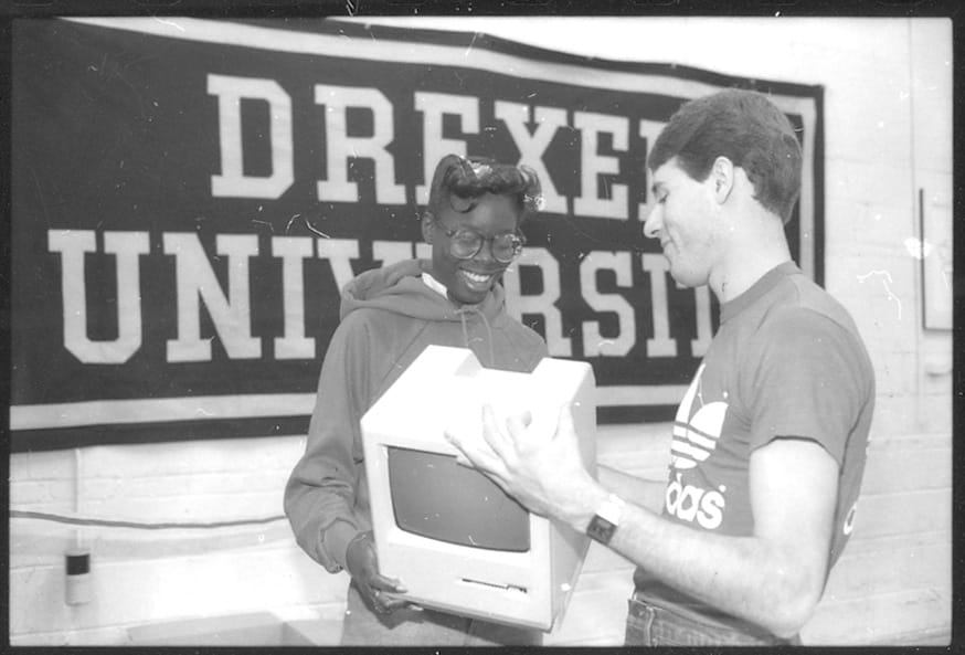 Two Drexel students holding the Macintosh in 1984. Photo courtesy Drexel University Archives.