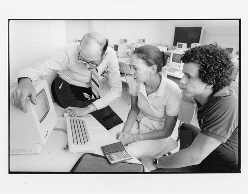 A professor using a computer as students watch. Photo courtesy Drexel University Archives.