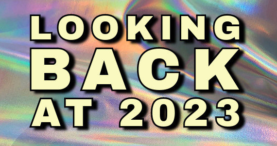 A shiny metallic background with words that read Looking Back at 2023