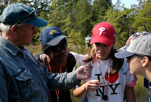 Students and professor examining a specimen