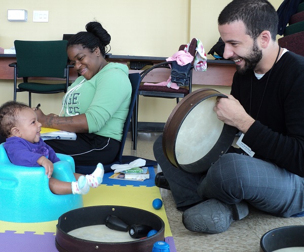 Music therapy with infant at the Stephen and Sandra Sheller 11th Street Family Health Services