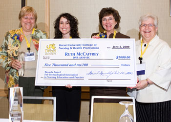 big check and 4 nursing professionals