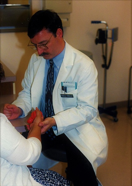 Ken Korber examining a patient with suspected digital thrombophlebitis in 2000.