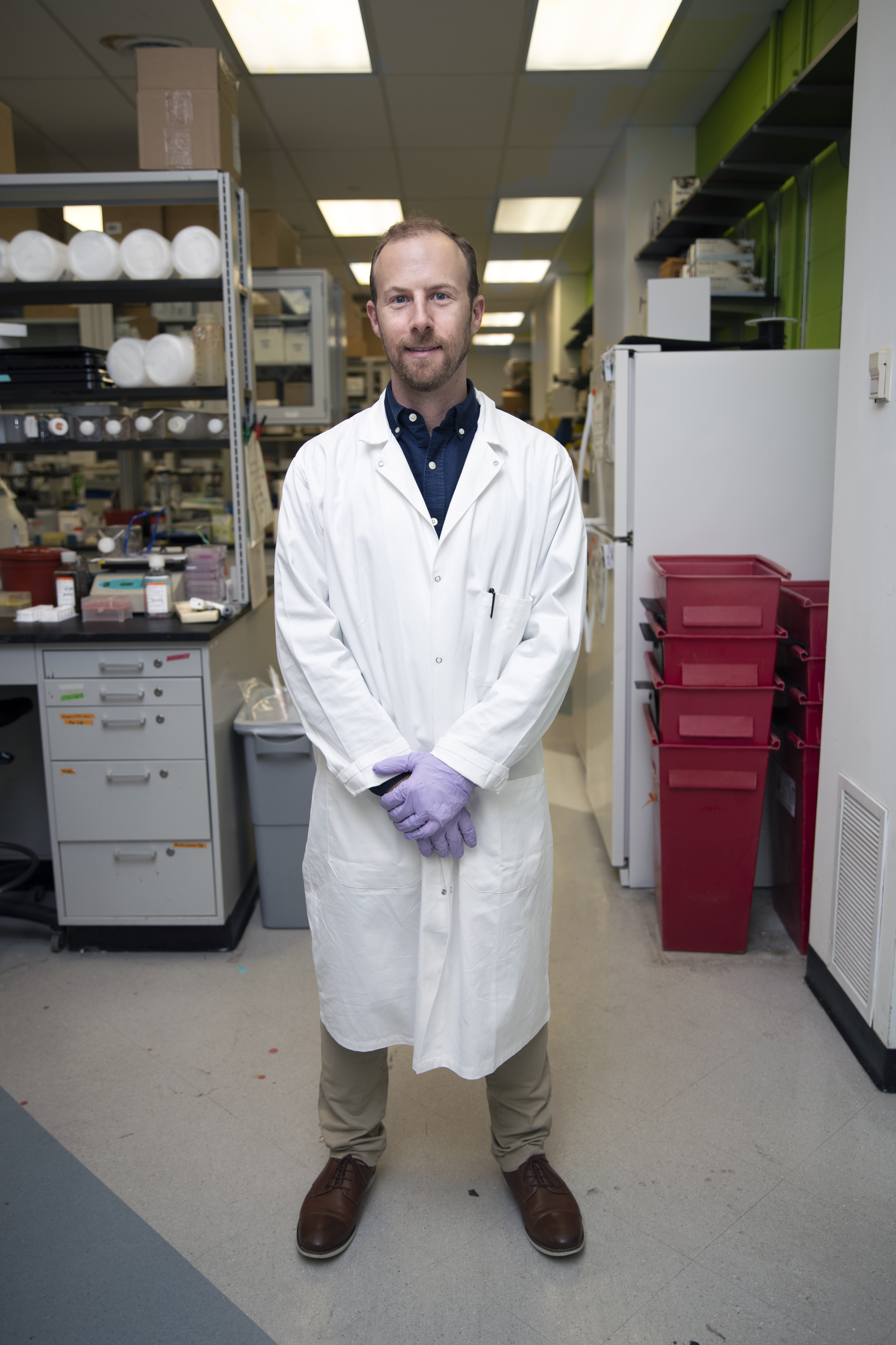 Ben Binder-Markey stands in lab coat