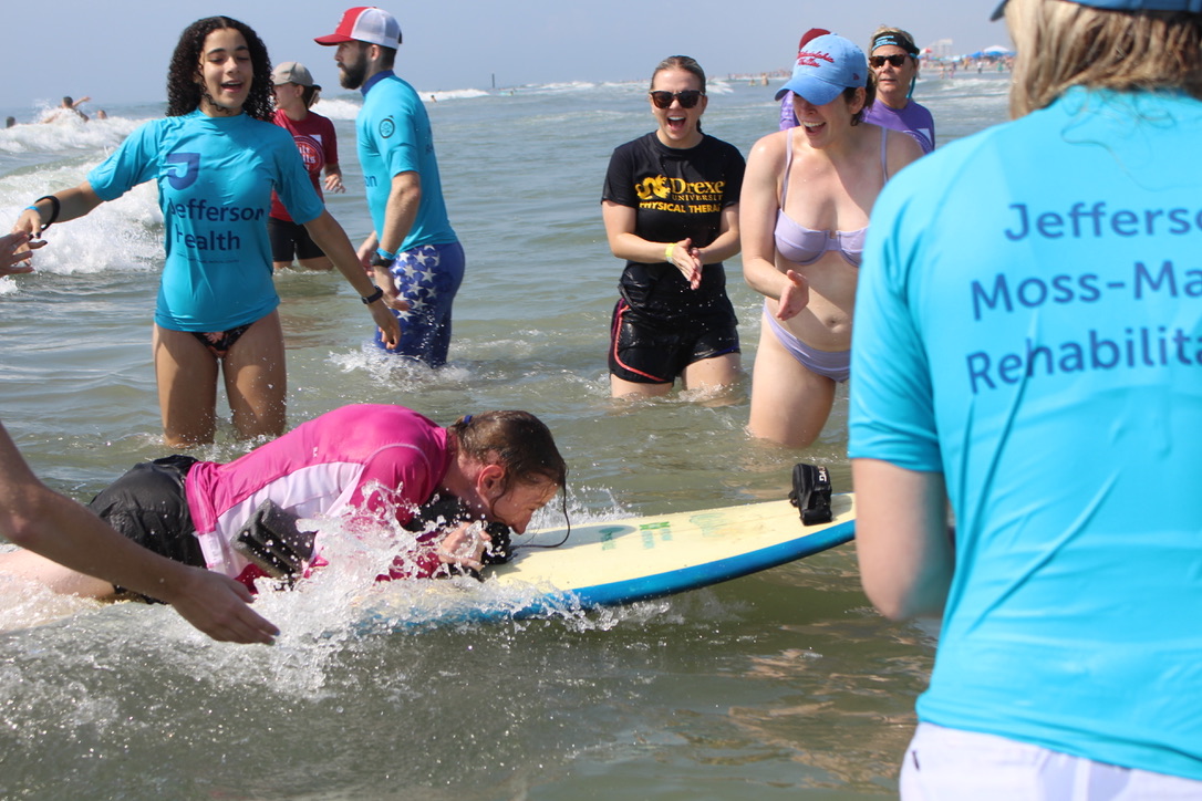 Students assisting with adaptive surfing at Life Rolls On in Wildwood NJ