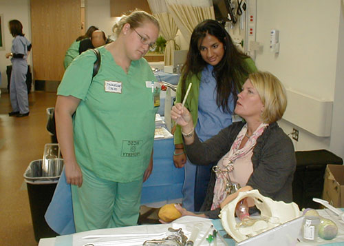 students observing faculty nurse