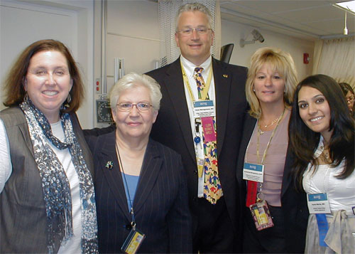 Dean Gloria Donnelly surrounded by four sim attendees