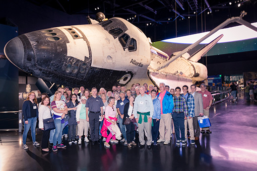 Alumni and guests in front of the space shuttle Atlantis.