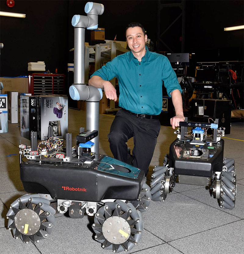 Dr. James Hing working with robots