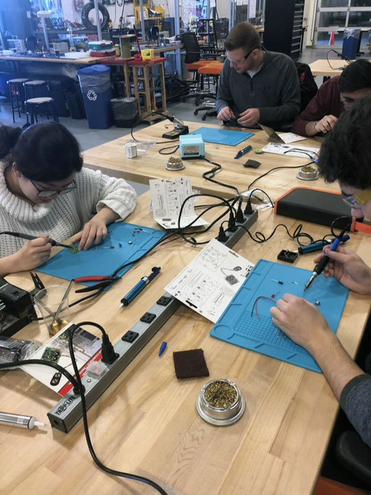 Students working on electronics project.