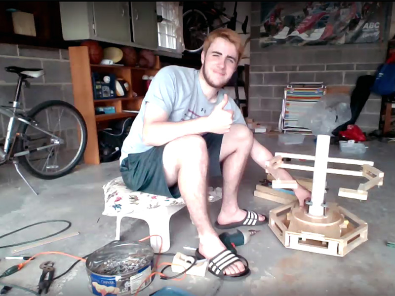 Student working on animatronic project in garage