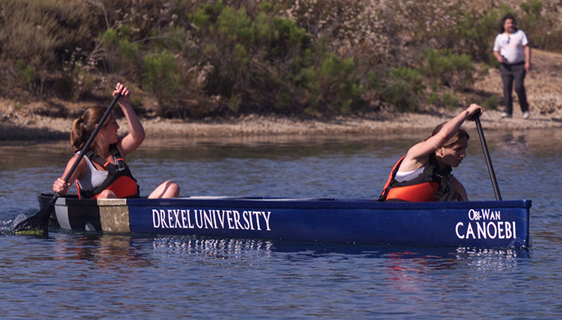 Students rowing a concrete canoe
