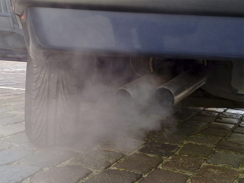 Car spewing smoke from its exhaust