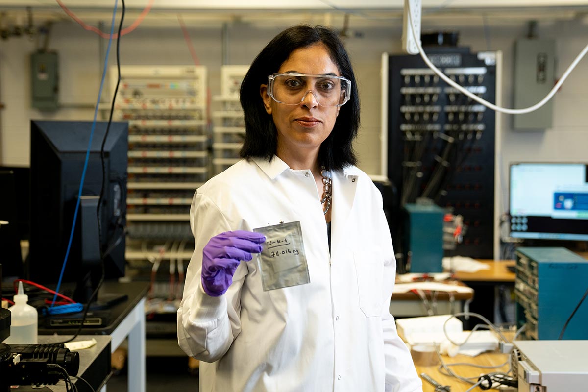 Vibha Kalra, PhD holds bag of new ion
