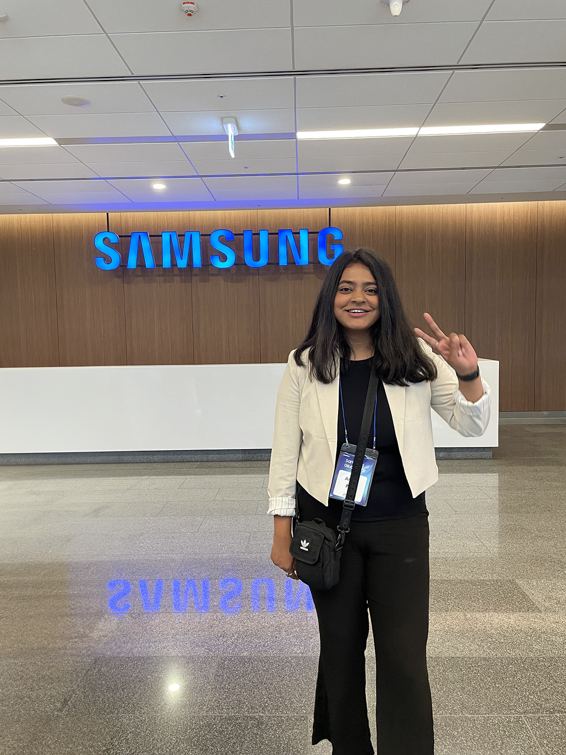 Ankita Paul stands in front of a Samsung sign