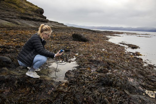 Emily collecting microbe samples in Iceland
