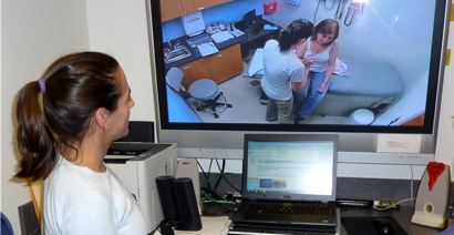 Nursing student watching observation monitor