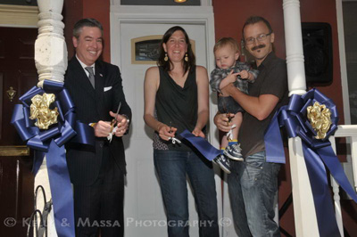 Ribbon cutting ceremony for first house bought under the Home Purchase Assistance Program