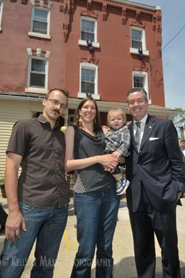 Ribbon cutting ceremony for first house bought under the Home Purchase Assistance Program