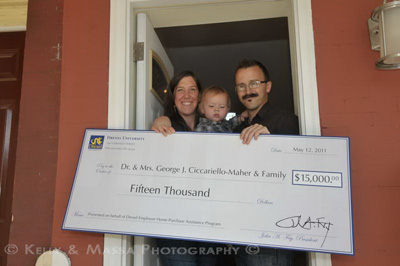 Ribbon cutting ceremony for first house bought under the Home Purchase Assistance Program