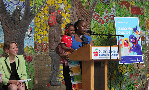Witness Sherita and her daughter Joeanna speaking at a podium at the St. Christopher's Children's Hospital