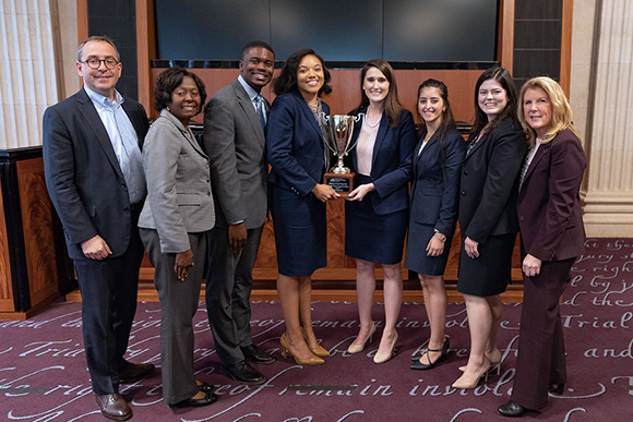 Maryland University Carey School of Law students pose with the tournament trophy.