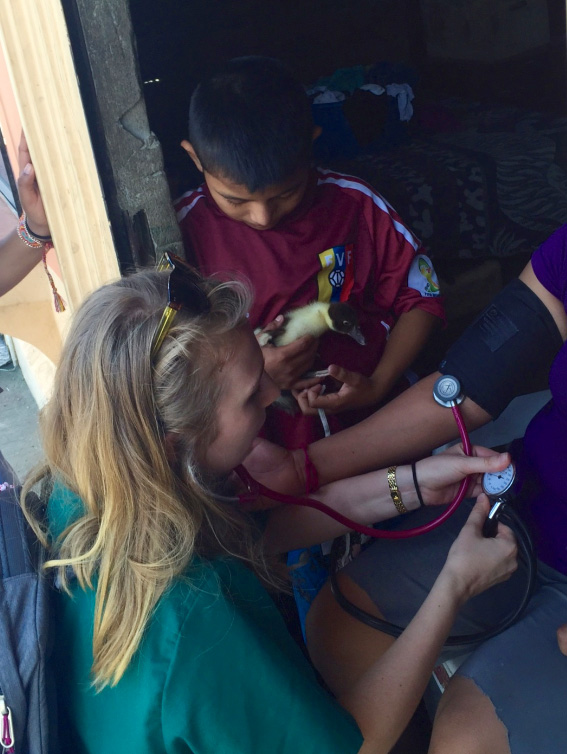 Drexel medical student Anya Golkowski takes a clinic patient's blood pressure.