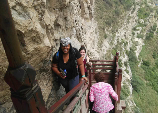 Drexel MD student Chalon Forbes climbing the Hanging Monastery in Datong.