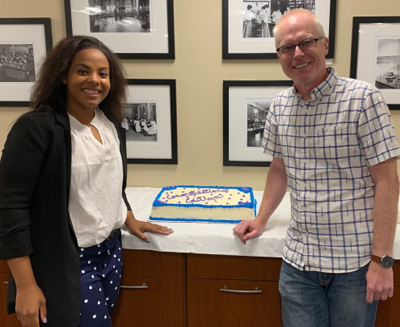 Caitlyn Rice and Ole Mortensen celebrate Caitlyn's thesis defense with a cake