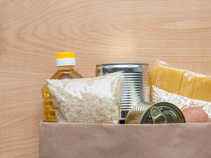 Set of grocery items in paper bag.