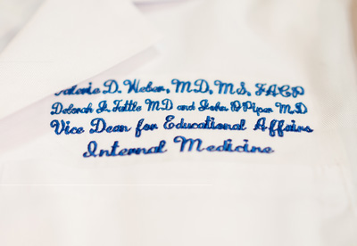 Valerie Weber's white coat embroidered with her new title