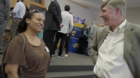 Faith Witherspoon, a ULAR employee and a student in the online MLAS program, chats with Paul McGonigle, PhD.