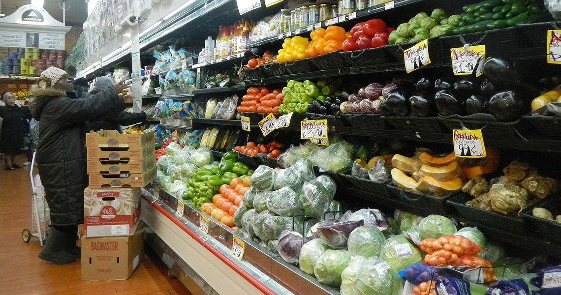 Senior shopping for vegetables in grocery store
