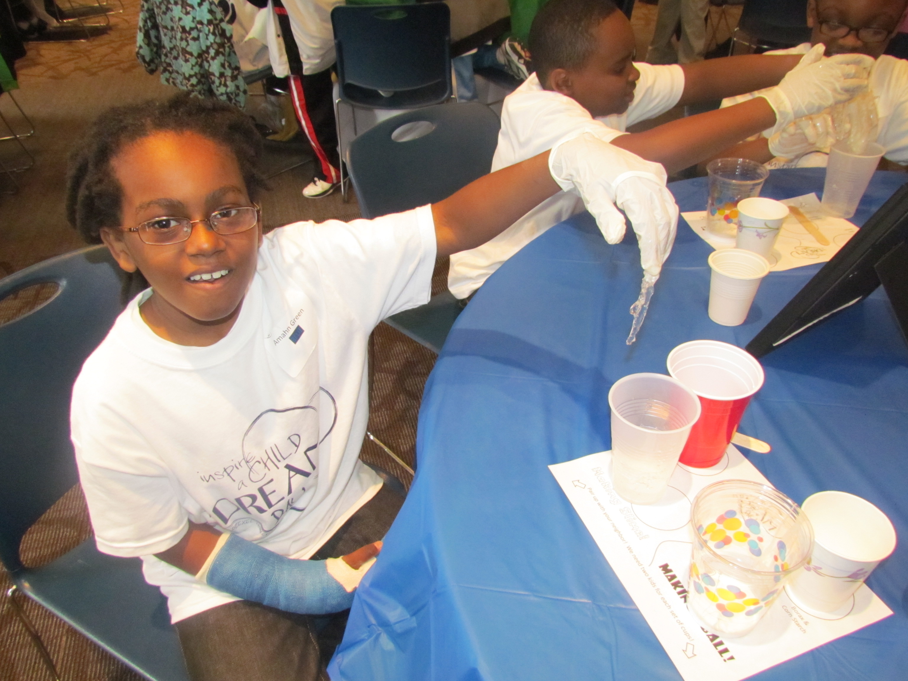 A young participant makes slime at Inspire a Child to Dream Day 2012