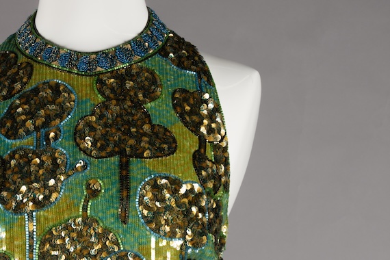 dress with elaborate beaded pattern on mannequin