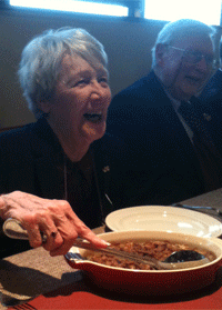 Dorcas Reilly serving casserole