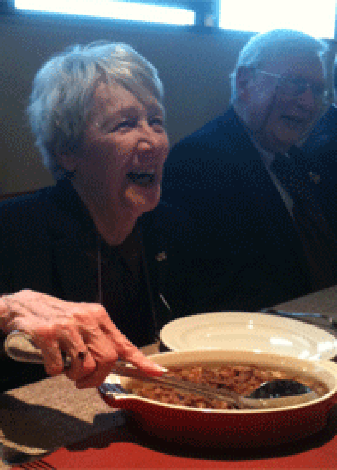 Dorcas Reilly serving casserole