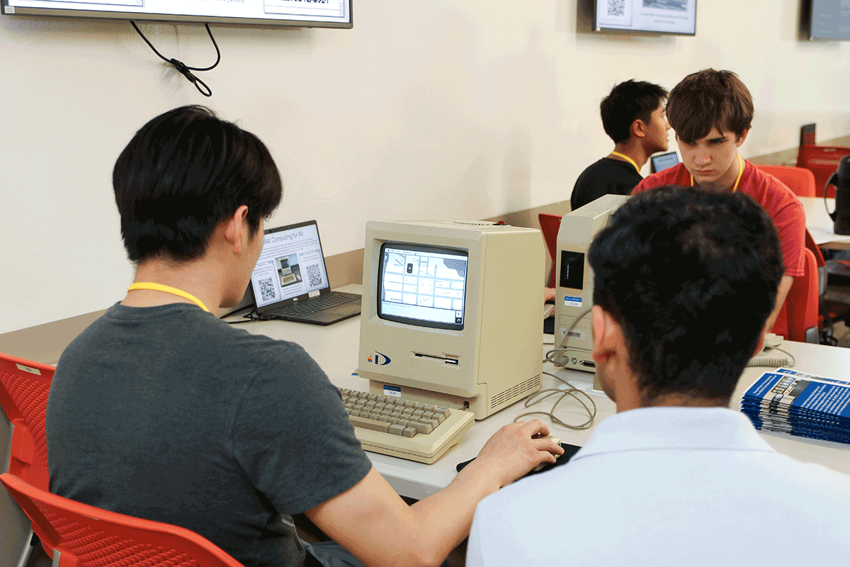 Attendees playing on a 1984 Drexel Machintosh