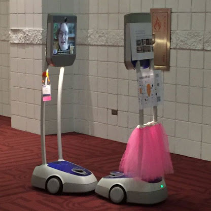 Photo of two telepresence robots interacting