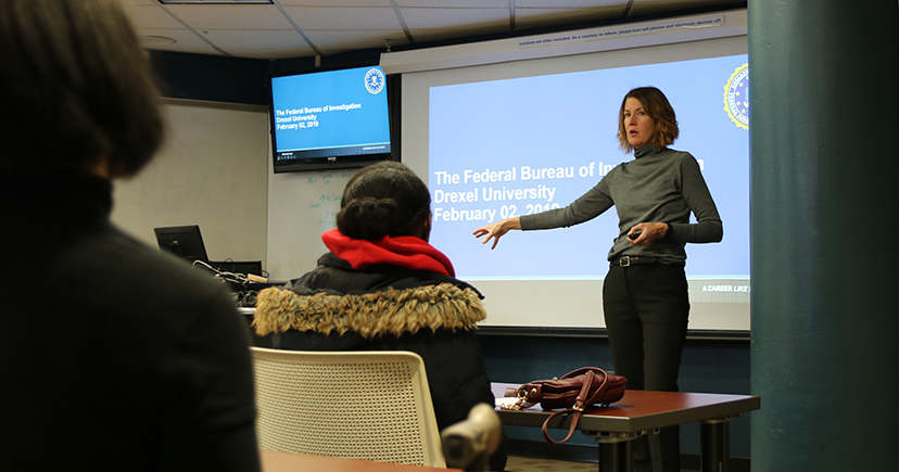 Special Agent Cerena J. Coughlin presents on career opportunities in the FBI during a cyber security workshop for high school students