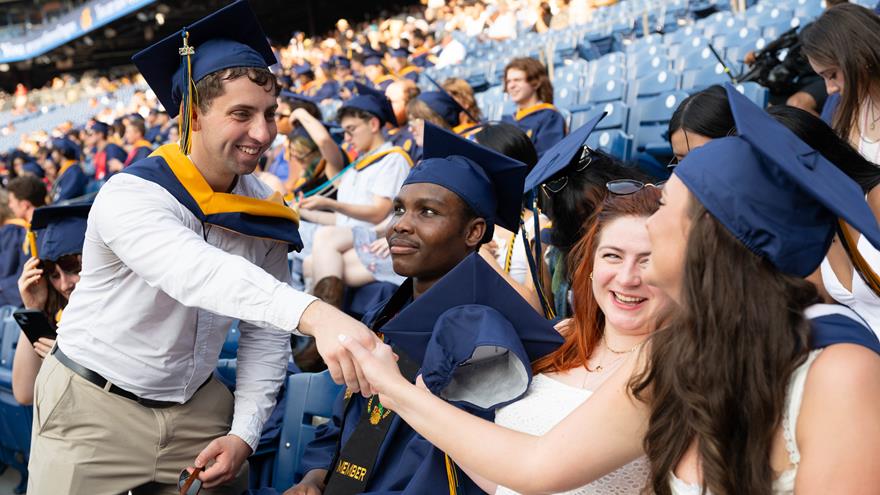 Students shaking hands in the stands