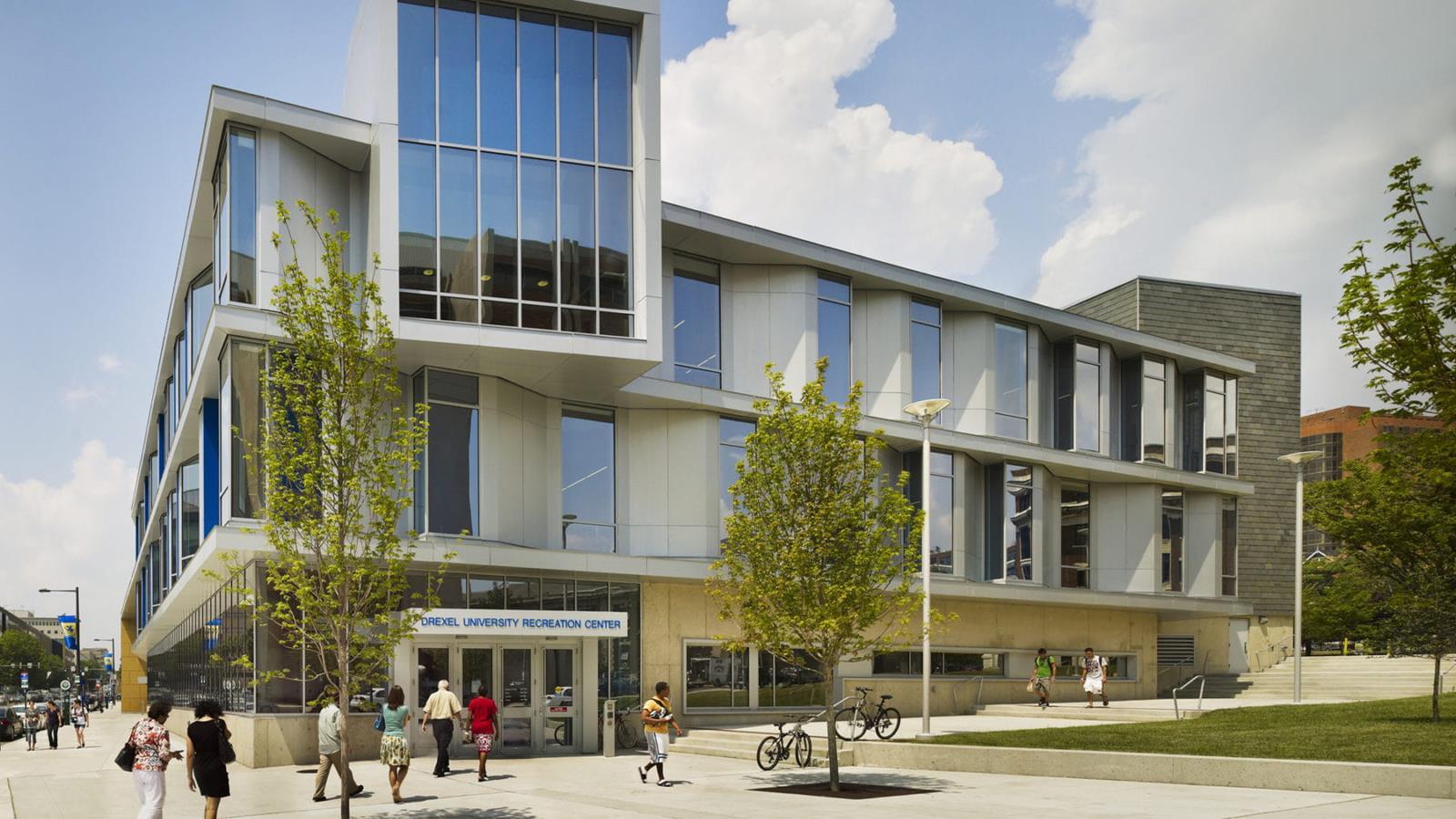 Exterior view of the Drexel University Recreation Center, a large, two-story building with several glass windows on both floors.