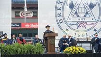 Moogega Cooper speaking at a podium at Drexel's Commencement.
