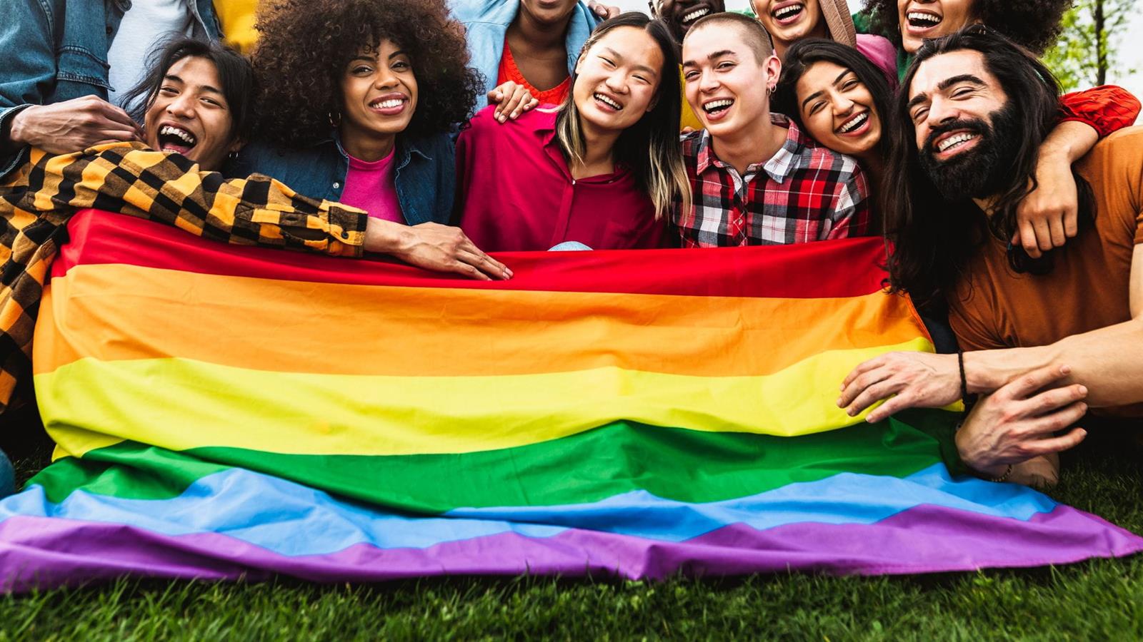 LBGTQIA group holding rainbow flag